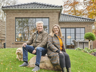 Maiken og Johnny med hunden Sergio foran deres nybyggede drømmehus i Hornbæk.